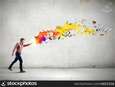 Man magician. Young man in casual throwing colorful paint splashes