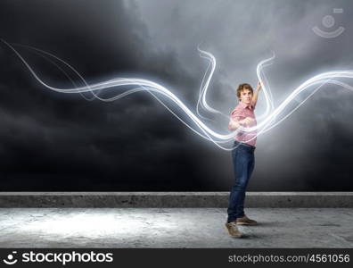 Man magician. Young man in casual throwing magic light