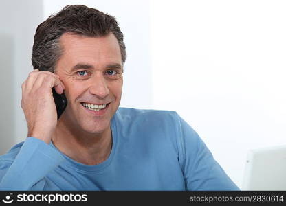 Man making a phone call at home