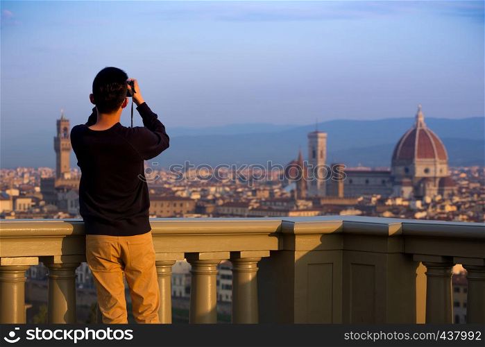 man making a photo shoot of Florence with the camera