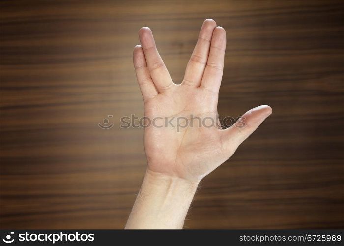 Man making a Vulcan Salute with his hand.