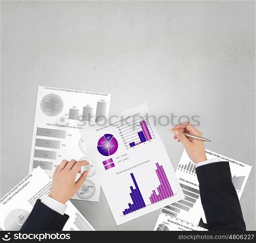 Man making financial notes. Businessman hands writing with pen infographs on paper