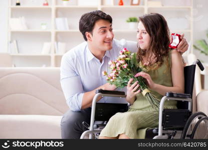 Man making marriage proposal to disabled woman on wheelchair