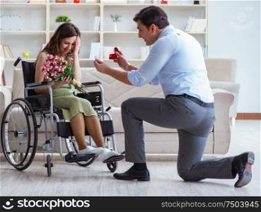 Man making marriage proposal to disabled woman on wheelchair. The man making marriage proposal to disabled woman on wheelchair