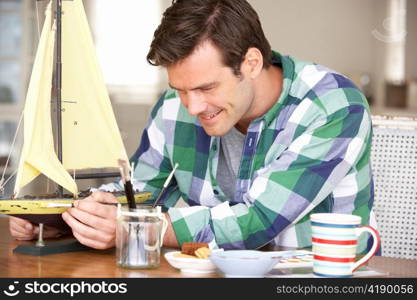 Man making model ship