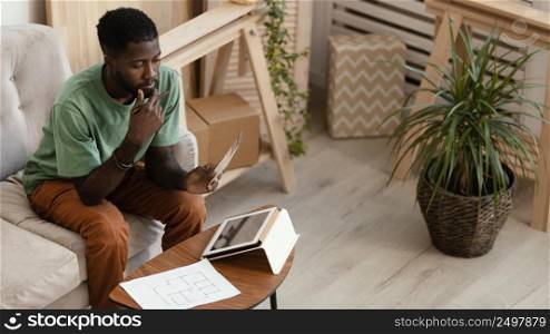 man making plan redecorate house using tablet