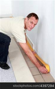 Man making preparations to fit new carpet