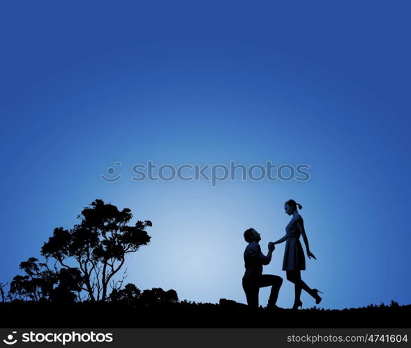 Man making proposal. Silhouettes of romantic couple under the moon light