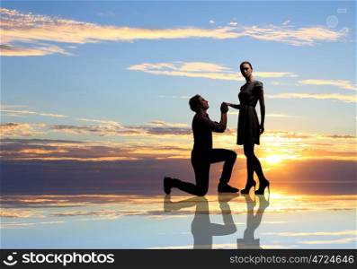 Man making proposal. Young man standing on knees and proposing a woman