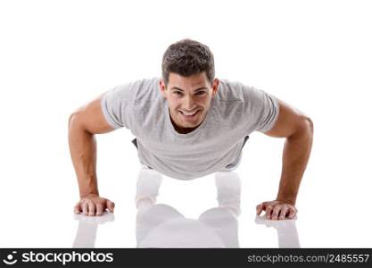 Man making pushups in studio, isolated over a white background