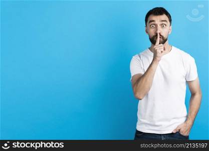 man making quiet gesture