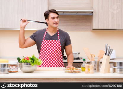 Man male cook preparing food in kitchen