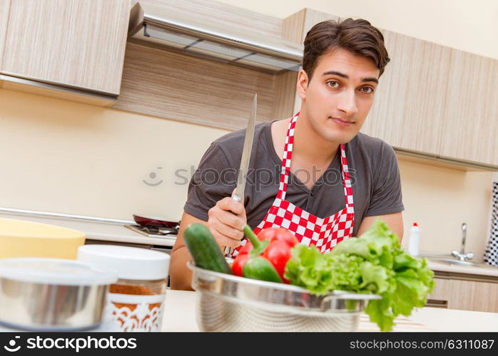 Man male cook preparing food in kitchen