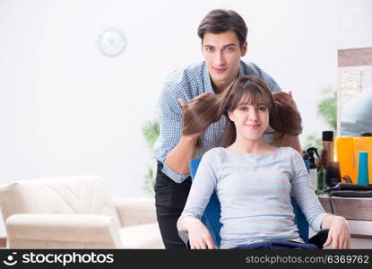 Man male hairdresser doing haircut for woman