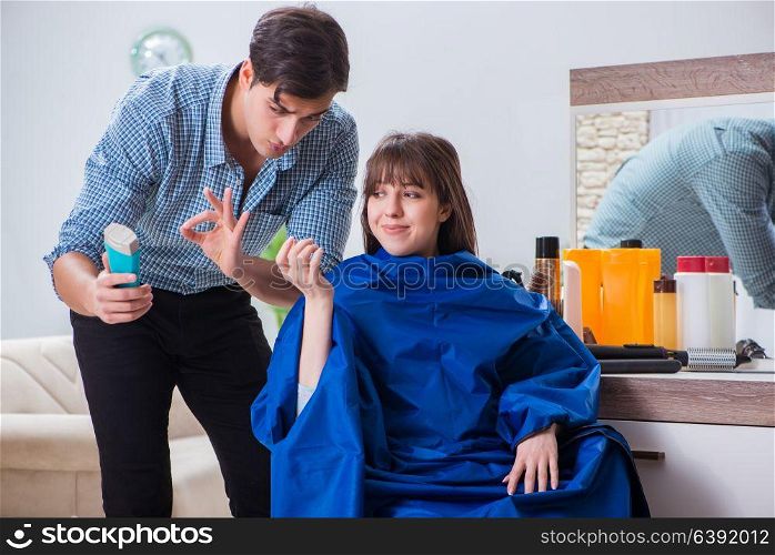 Man male hairdresser doing haircut for woman