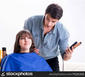 Man male hairdresser doing haircut for woman. The man male hairdresser doing haircut for woman