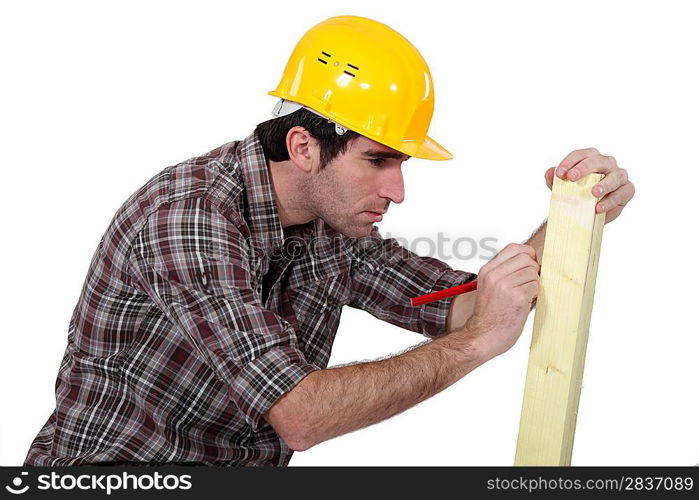 Man marking wood