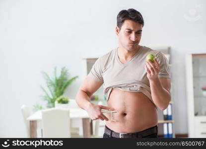 Man measuring body fat with calipers