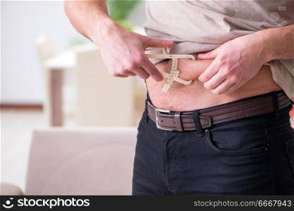 Man measuring body fat with calipers
