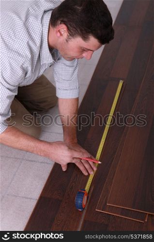 Man measuring flooring