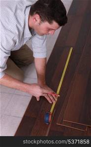 Man measuring flooring