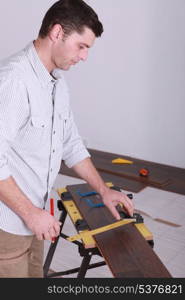 Man measuring plank of wood