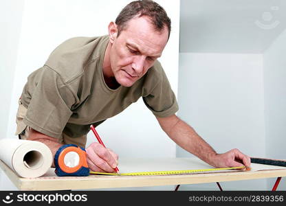 Man measuring wallpaper