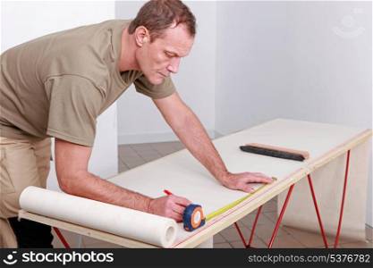 Man measuring wallpaper