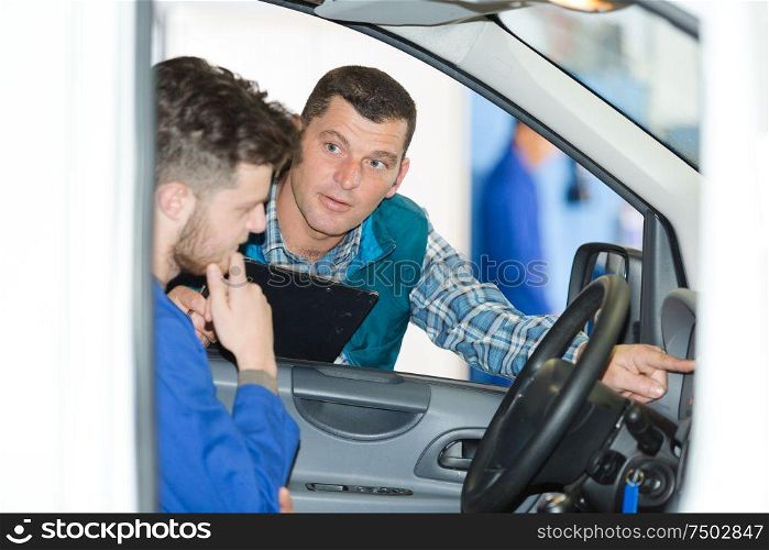 man mechanic inside of a car