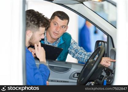 man mechanic inside of a car