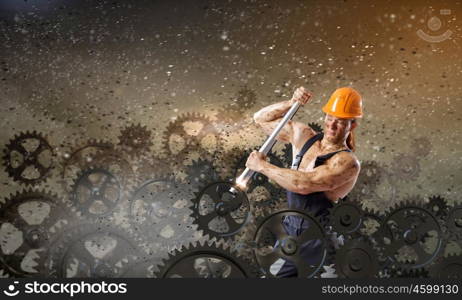 Man mechanic. Strong man mechanic in uniform with spanner fixing mechanism