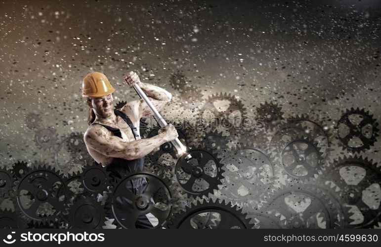 Man mechanic. Strong man mechanic in uniform with spanner fixing mechanism