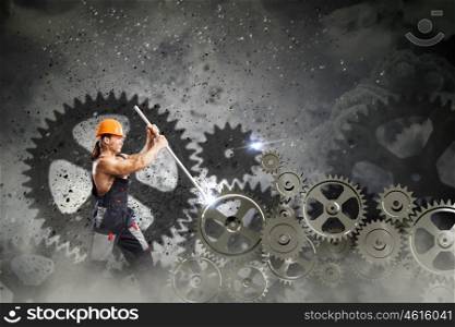 Man mechanic. Strong man mechanic in uniform with spanner fixing mechanism