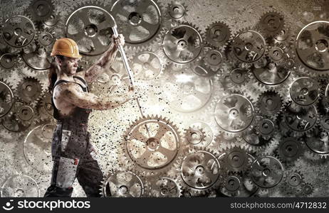 Man mechanic. Strong man mechanic in uniform with spanner fixing mechanism