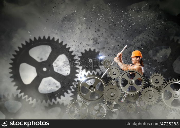 Man mechanic. Strong man mechanic in uniform with spanner fixing mechanism