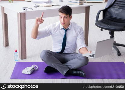 Man meditating in the office to cope with stress