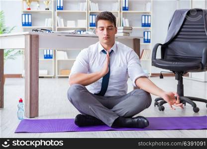 Man meditating in the office to cope with stress