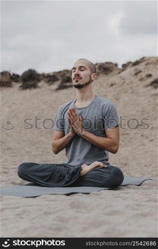 man meditating outdoors while doing yoga