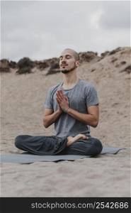 man meditating outdoors while doing yoga