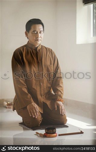 man meditating with singing bowl incense