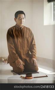 man meditating with singing bowl incense