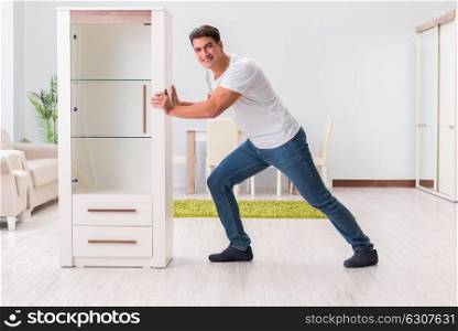 Man moving furniture at home