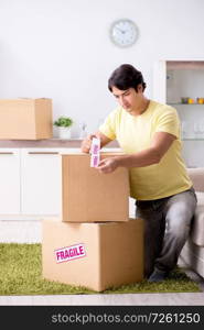 Man moving house and relocating with fragile items. The man moving house and relocating with fragile items