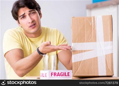 Man moving house and relocating with fragile items