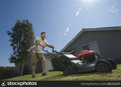 Man moving lawn low angle