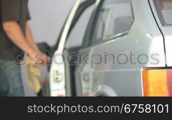 man nand with microfiber cloth polishing car