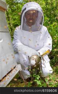 Man next to bee hive