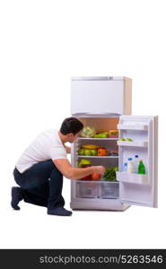 Man next to fridge full of food