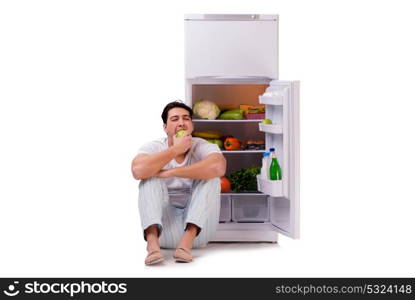 Man next to fridge full of food