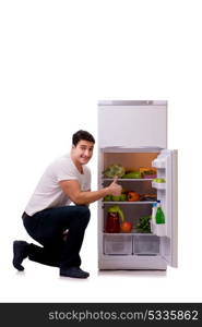 Man next to fridge full of food